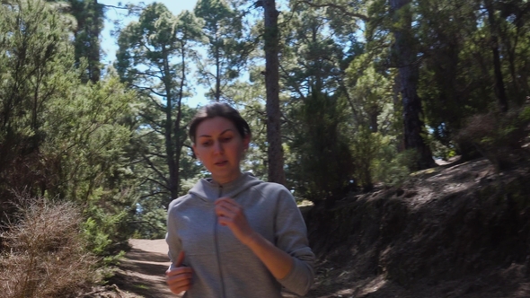 Girl Athlete Running in the Woods