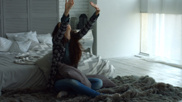 Positive Woman Stretching Her Arms in Bedroom