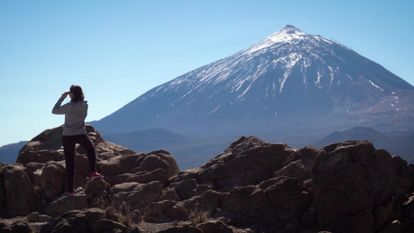 Tourist Looks at the Teide Volcano with Binoculars