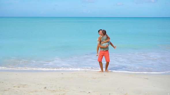 Little Girl and Happy Dad Having Fun During Beach Vacation