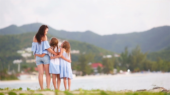 Beautiful Mother and Daughters on Caribbean Beach in Sunset. Family on Beach Vacation.