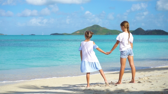 Adorable Little Girls Walking on the Beach and Having Fun Together