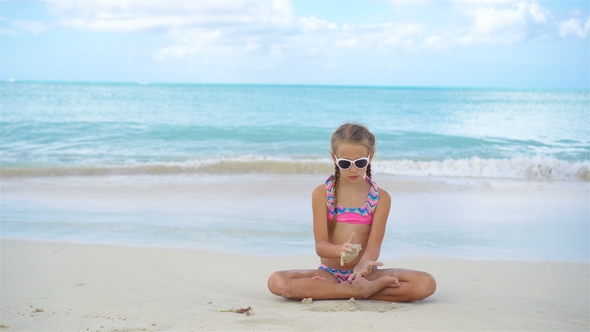Adorable Little Girl on the Beach During Summer Vacation