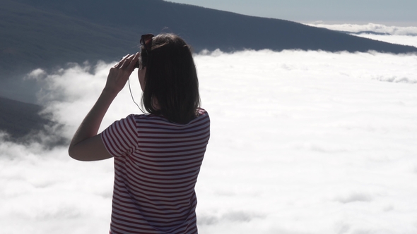 Girl Looks Through Binoculars at Clouds