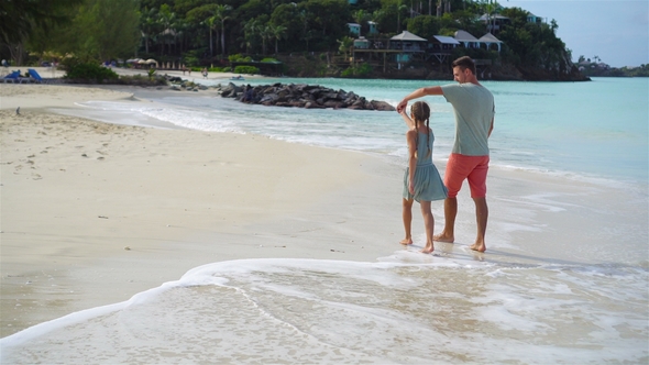 Family Walking on the Beach. Dad and Kid Together on the Seashore