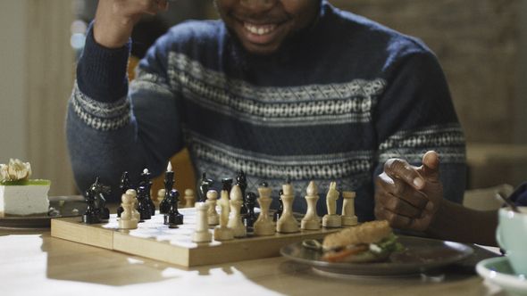 Content Black Men Playing Chess in Cafeteria