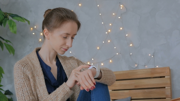 Woman Using Smart Watch at Home