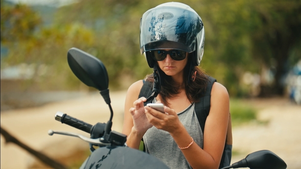 Portrait of Woman Biker Using the Map Application on the Smartphone