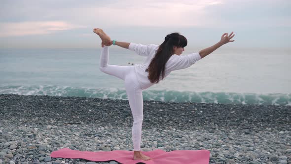 Woman in White Practicing Yoga.