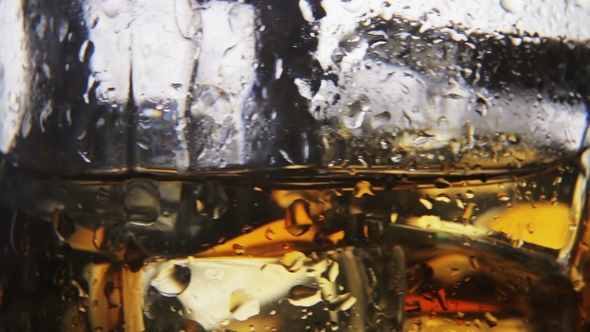 Whiskey in a Glass with Ice on a Light Background