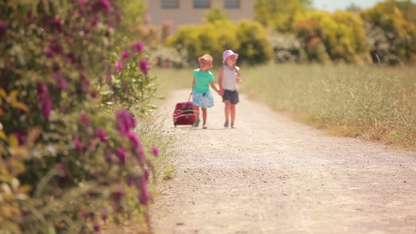 Happy Little Girl and Boy Holding Hands, Go on the Road