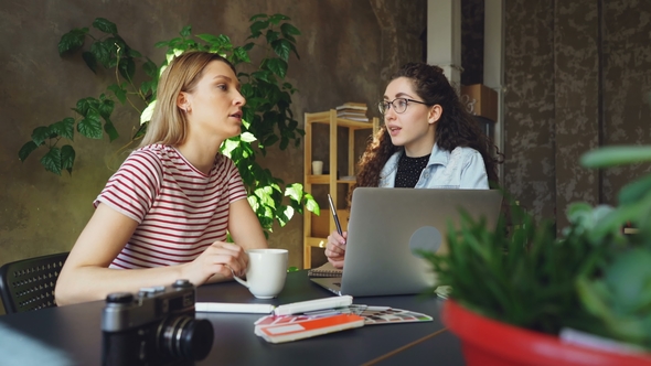 Female Students Sitting in Light Room Together and Socialising