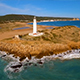 Aerial View of Lighthouse on the Coast during Sunset - VideoHive Item for Sale