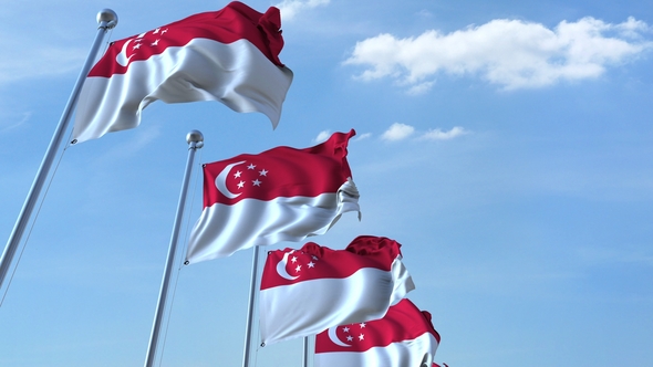 Waving Flags of Singapore Against the Sky