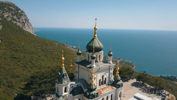 Orthodox Church on a Steep Cliff. Sea and Mountains on a Background. Aerial View of Foros Church on