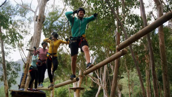 Group of woman and trainer walking on the logs 4k