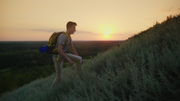 A Tired Teenager Rises To the Mountain. At Sunset, Carries a Backpack Behind Her Back