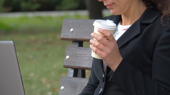 Business Woman with Laptop Drinking Coffee