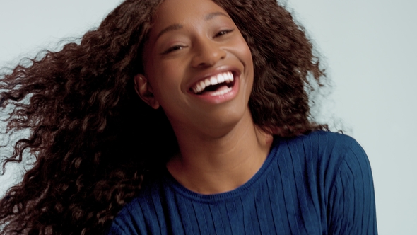 Beauty Black Mixed Race African American Woman with Long Curly Hair and Perfect Smile