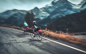 ortrsmans riding on the bicycles on the mountainous road in Alp, Italy, Europe