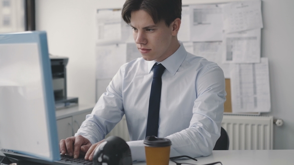 Tired Thoughtful Man Working Deligently with Pc in Office