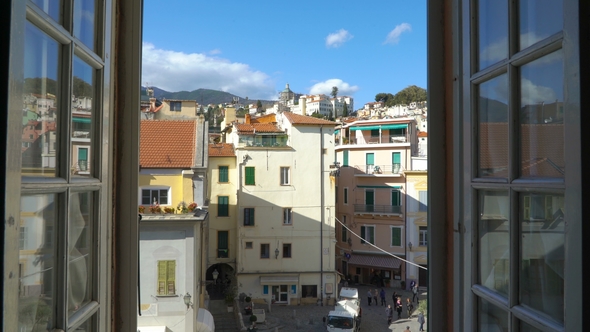 Young Woman Opening Window at Morning in Italian Medieval Town