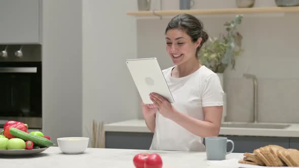 Indian Woman Using Tablet in Kitchen