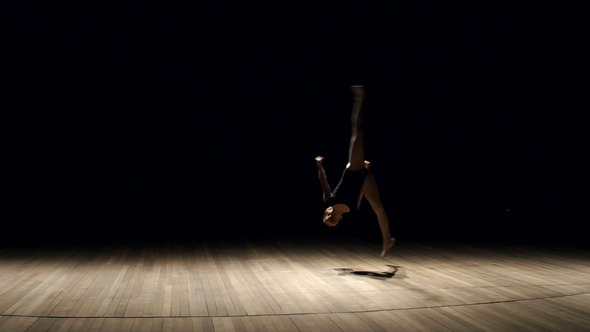 Flexible Girl Makes Gymnastic Somersault on Stage.