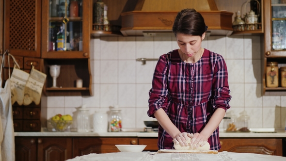 A Woman Kneading Pizza Dough in Her Kitchen