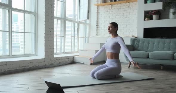 Young Happy Woman Practicing Yoga and Doing Breathing Exercises Watching Live Video Learning Classes