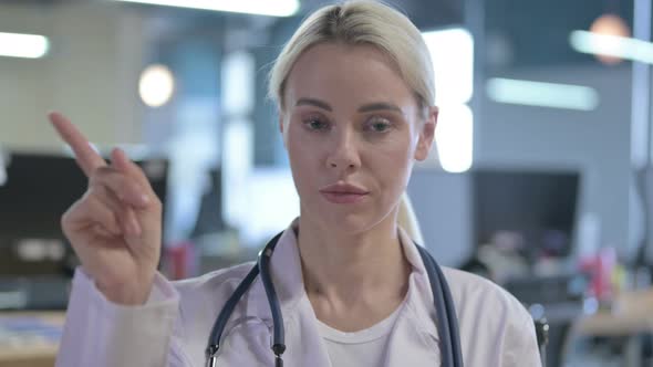 Portrait of Female Doctor Saying No By Finger Sign