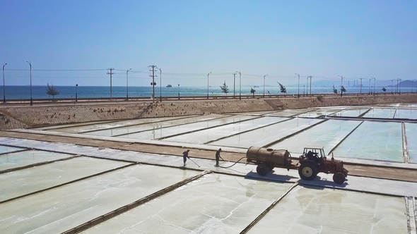 People Clean Salt on Site Pouring Water with Hose