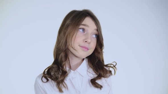 Portrait of Hesitant Girl Blinking Her Big Eyes at Camera