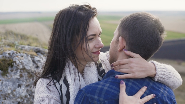 Lovely Man Embraces and Kisses His Woman on Nature.