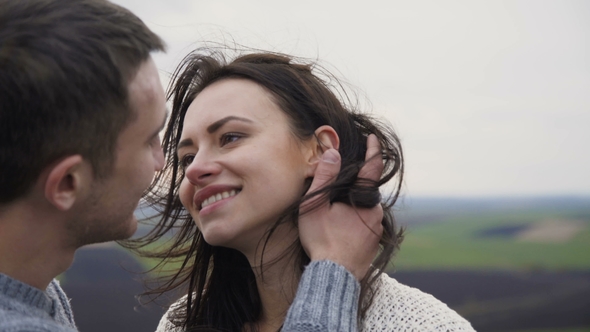 Lovely Man Kisses His Girl on the Rock.