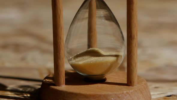 Bottom Portion of an Hourglass with Yellow Sand. Close Up