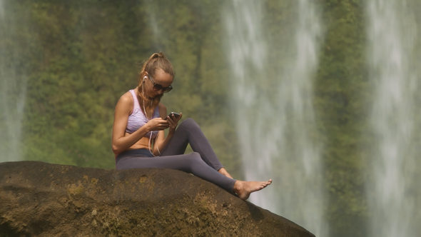 Girl Listens to Music and Reads Messages on Phone