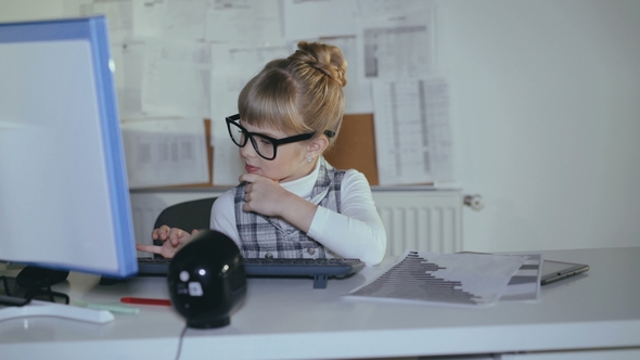 Cute Little, Clever Schoolgirl Using Pc and Tablet at Workplace.