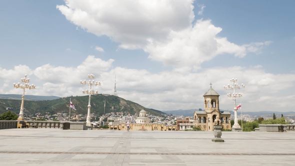 Young Girl Looking at Holy Trinity Cathedral of Tbilisi Tsminda Sameba in Georgia