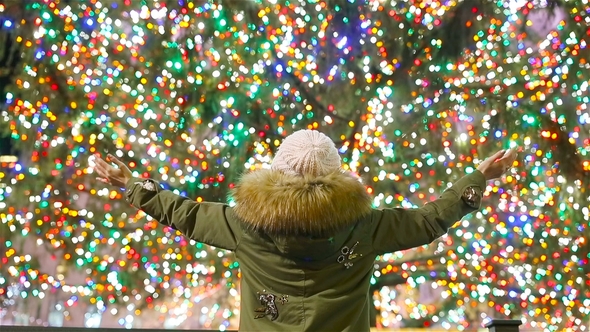 Happy Girl on the Background of the Rockefeller Christmas Tree in New York