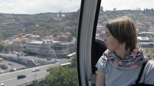 Girl Looks through the Window in the Cableway in Tbilisi, Georgia