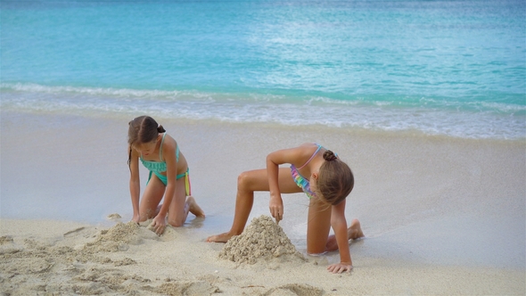 Adorable Little Girls During Summer Vacation on the Beach