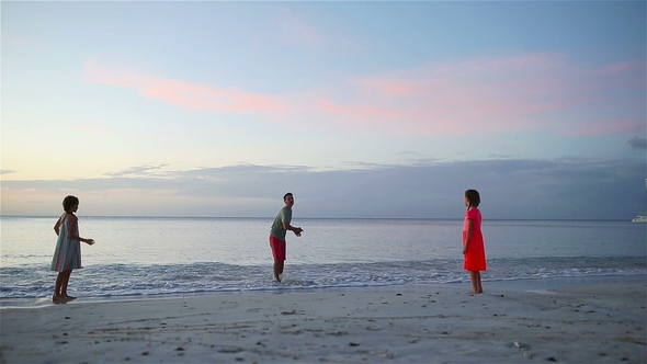 Happy Family Playing Together on the Beach