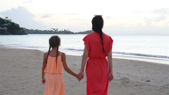 Young Beautiful Mother and Her Adorable Little Daughter Have Fun at Tropical Beach