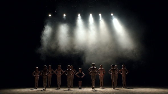 Silhouette of Children Dancing on Stage in the Dark.