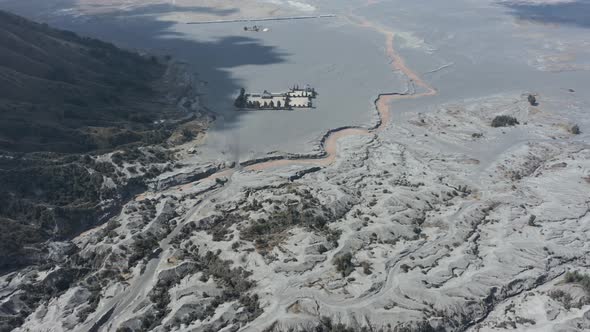 Drone view flying over a black volcanic sea of sand