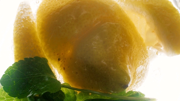 Footage of Lemon Slices and Mint Leaves Floating in Fresh Cold Lemonade