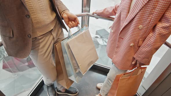 Stylish Couple In Glass Elevator In Shopping Centre