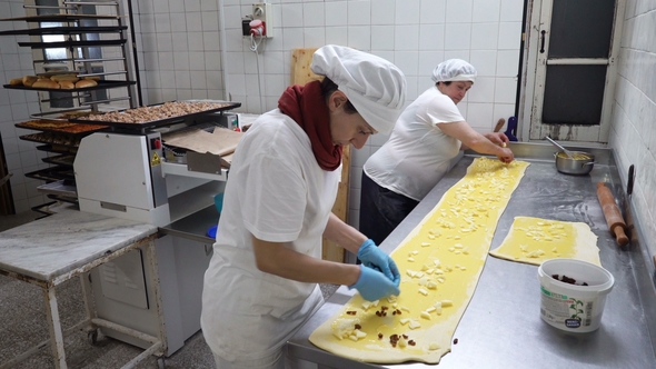 Traditional Italian Bakery. Two Female Bakers Prepare Sweet Buns with Cream Pasticcera