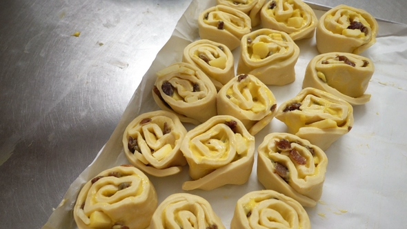 Two Female Bakers Prepare Sweet Buns with Cream Pasticcera, Raisins and